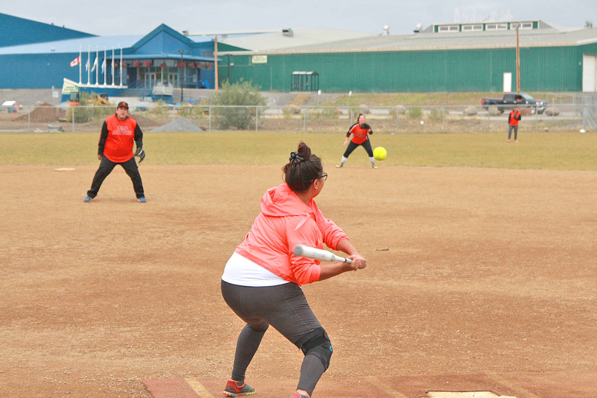 Loni Ruben winds up for an incoming pitch during the opening game of the Inuvik Slo-Pitch League championship tournament Aug. 20. Eric Bowling/NNSL photo