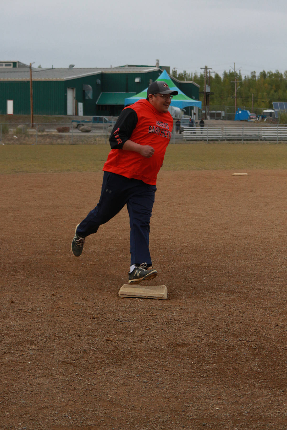 Charlton Wolki races past third base to home as the ball bounces around the outfield. Eric Bowling/NNSL photo