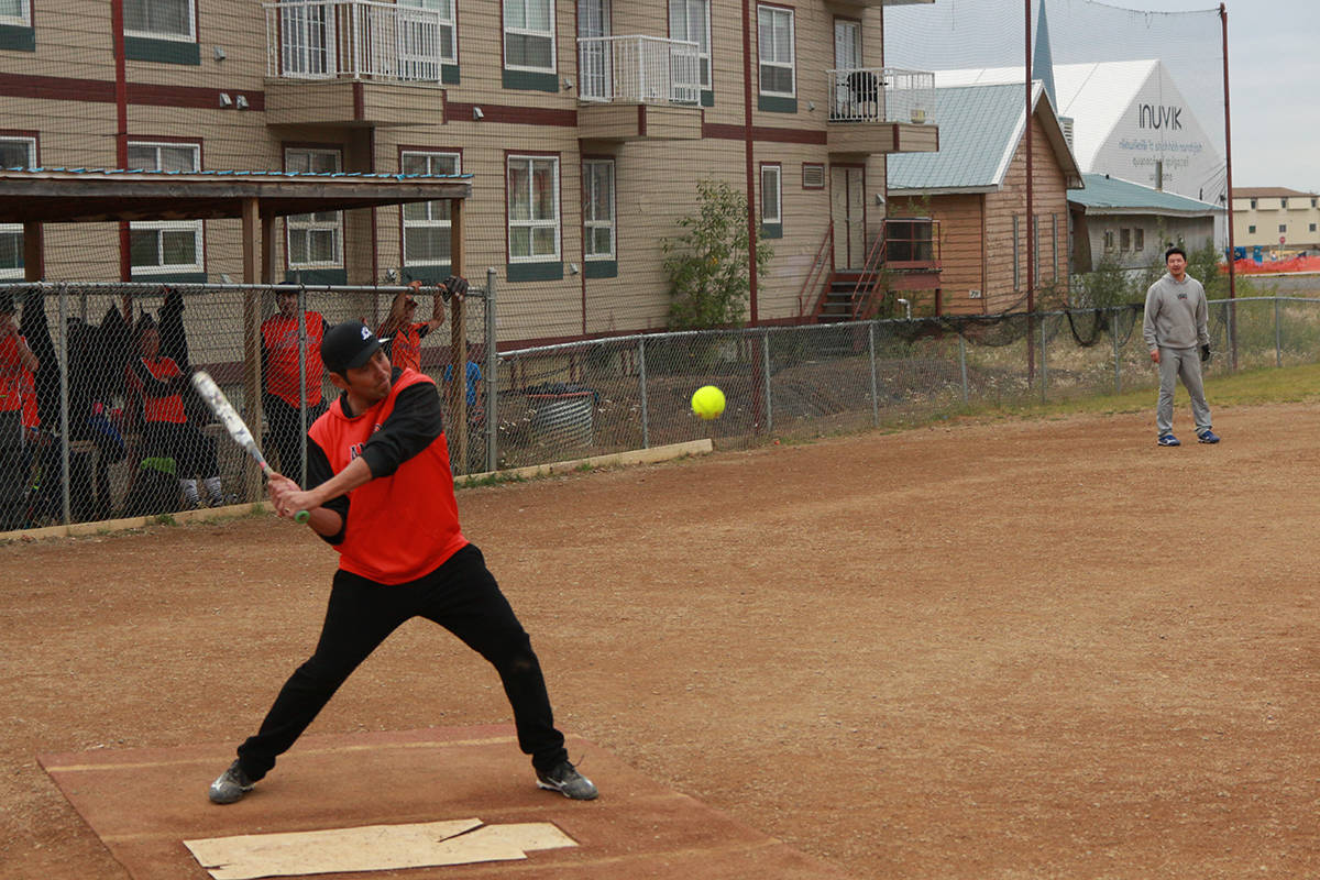 Tony Stefure lets loose on an incoming pitch as his team cheers him on. Eric Bowling/NNSL photo