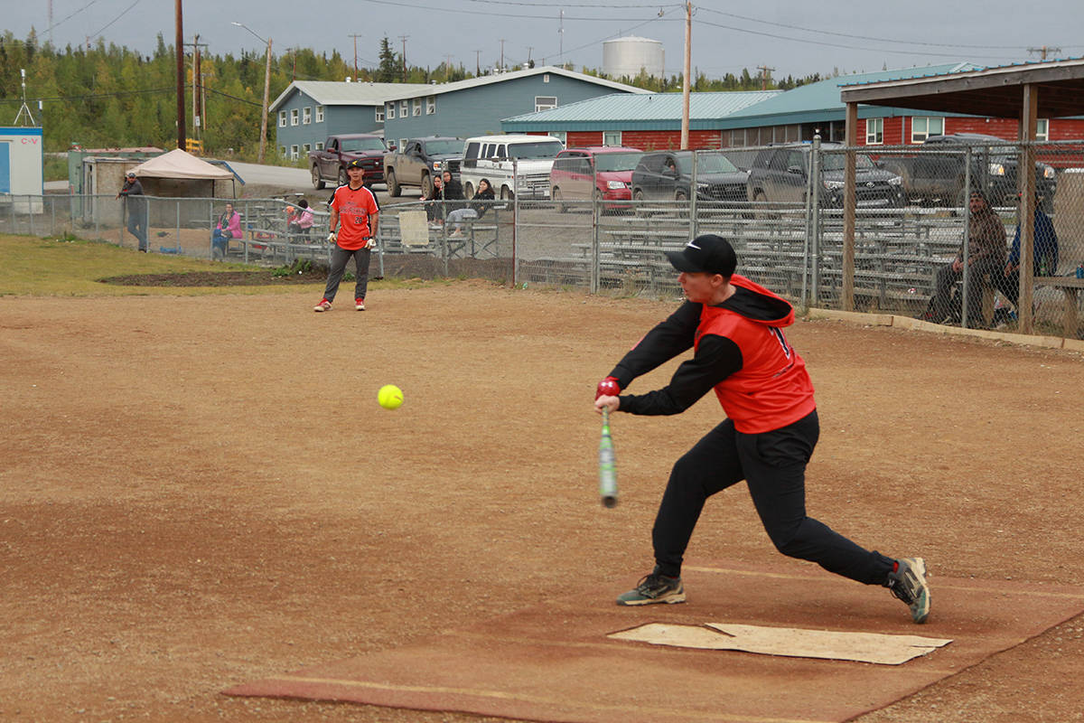 Jenn Parrot takes a swing at an incoming pitch as her team watches in anticipation. Eric Bowling/NNSL photo