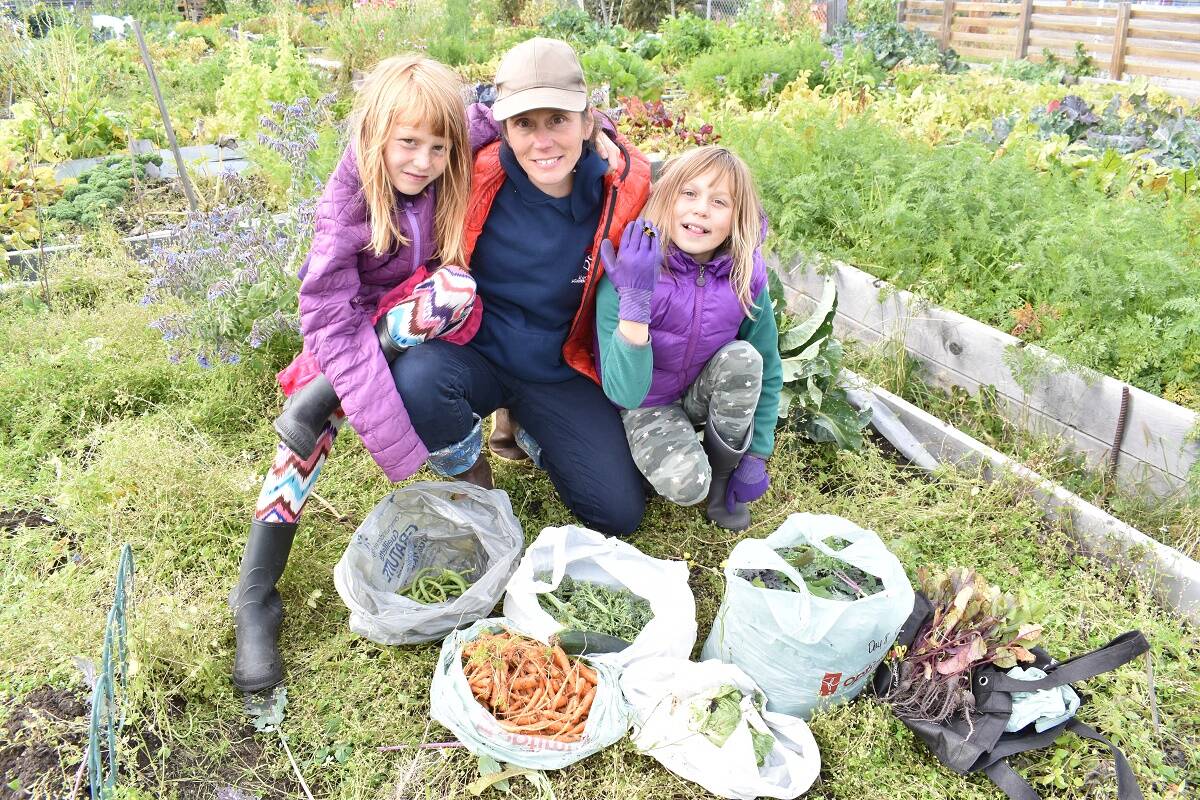 Arya Townson, left, Julie Ward and Lila Townson take a break from picking peas and potatoes. Blair McBride/NNSL photo