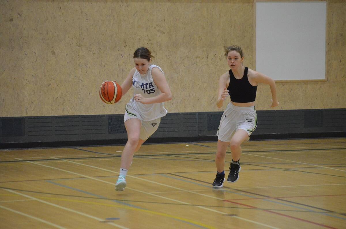 Taya Straker, left, starts the fast-break as Lily Lloyd gives chase during the U19 Eagles Basketball tryouts at St. Pats Gymnasium on Saturday. James McCarthy/窪蹋勛圖厙 photo