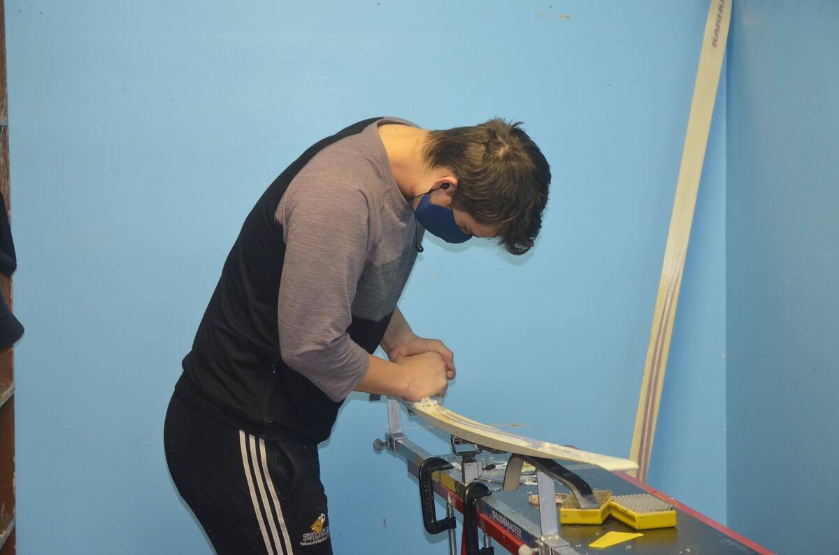 Makoa Kokelj works on waxing skis during the Yellowknife Ski Clubs Snow Show on Saturday. James McCarthy/ϳԹ photo