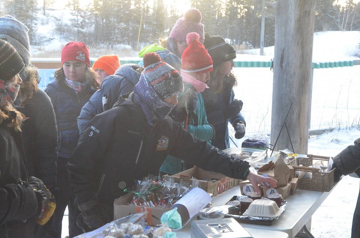 Toryn Wheler reaches for a cupcake at the bake sale table during the Yellowknife Ski Clubs Snow Show on Saturday. James McCarthy/ϳԹ photo