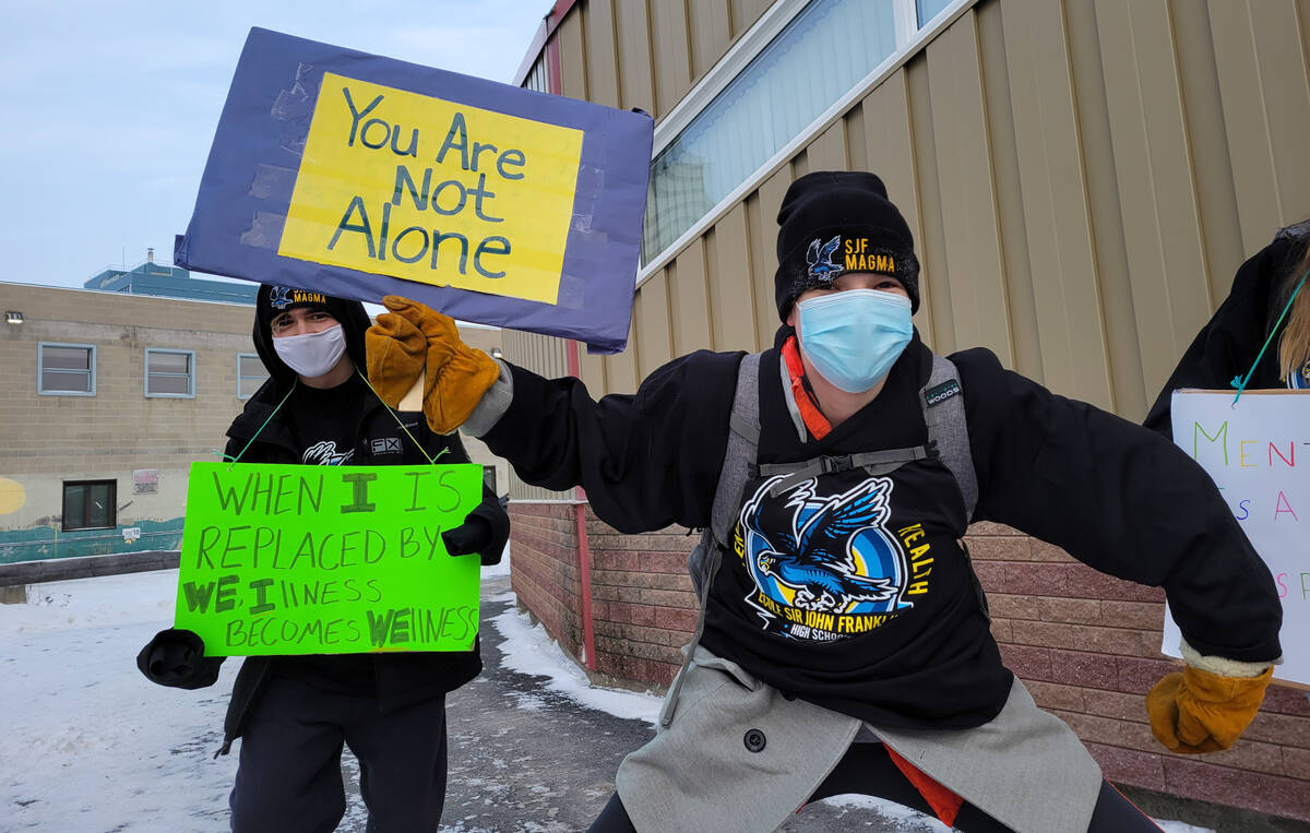 Tobie White, left, and Alex Barnes were a part of the walk with signs saying When I is replaced by We, Illness becomes Wellness and You are not alone. Ethan Butterfield/NNSL photo