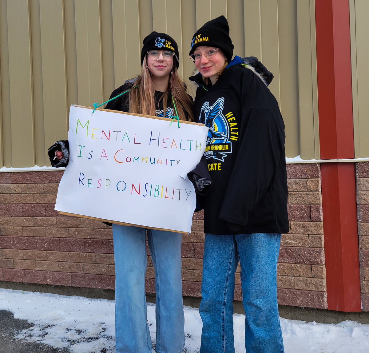 Annabella Churchill and Lacey Furniss with the sign Mental Health is a Community Responsibility. Ethan Butterfield/NNSL photo