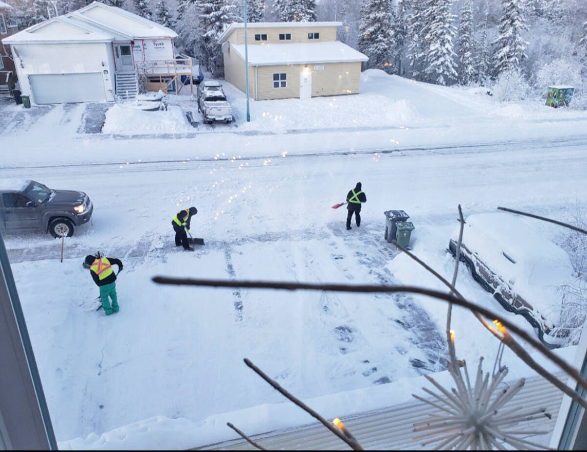 The Odd Job Squad worked right up to days end on Dec. 23. Customer Mieke Cameron captured this photo of the team on the job from the cozy comfort of her apartment. Photo courtesy of Inclusion NWT