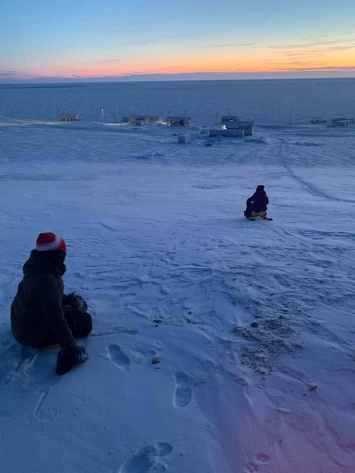 Our Youths of the Week are Nita Lucas, age 12 and Nevaeh Lucas-Elanik, age six, seen here getting some time on the toboggan before Sachs Harbour聮s first sunrise of the year! Both are big fans of language and phys ed classes, while Nita gravitates towards sciences and Nevaeh prefers to brush up on her art skills. Photo courtesy of Chelsey Lucas