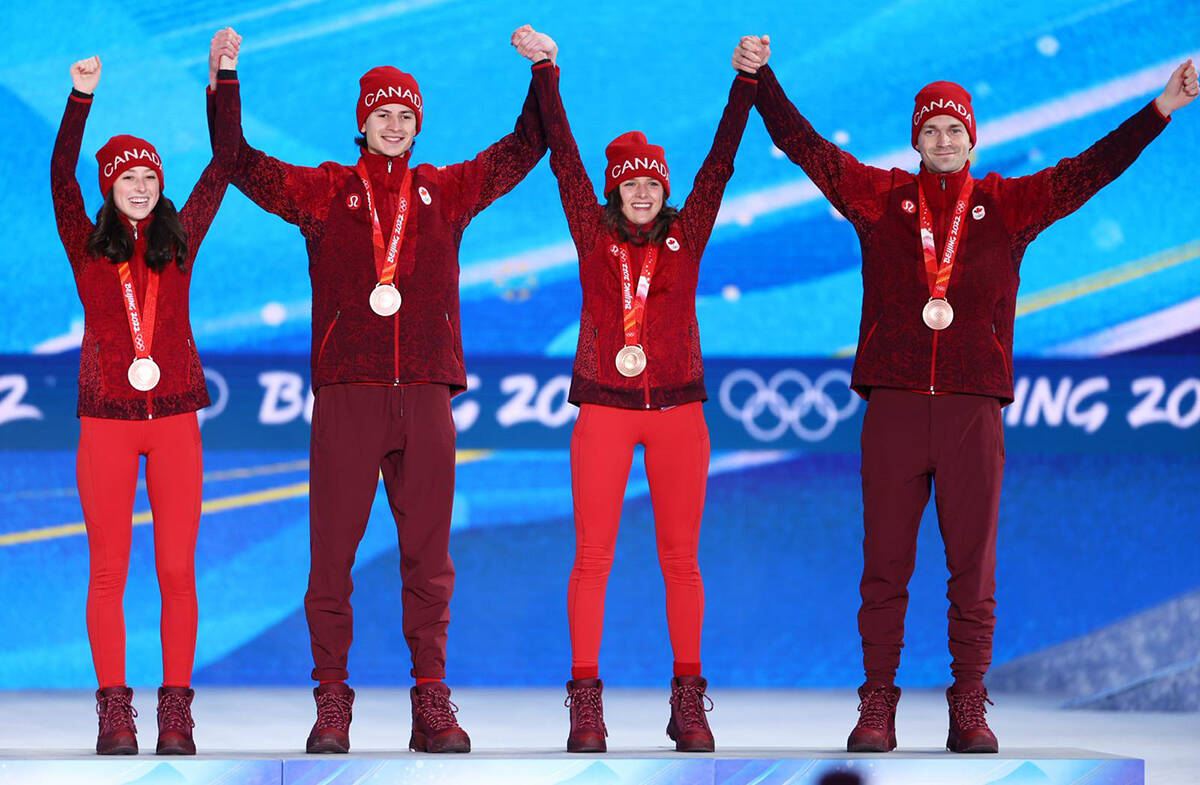 Alexandria Loutitt, left and teammates Matthew Soukup, Abigail Strate and Mackenzie Boyd-Clowes celebrate their surprise bronze medal win in Beijing. Photo courtesy of Alexandria Loutitt