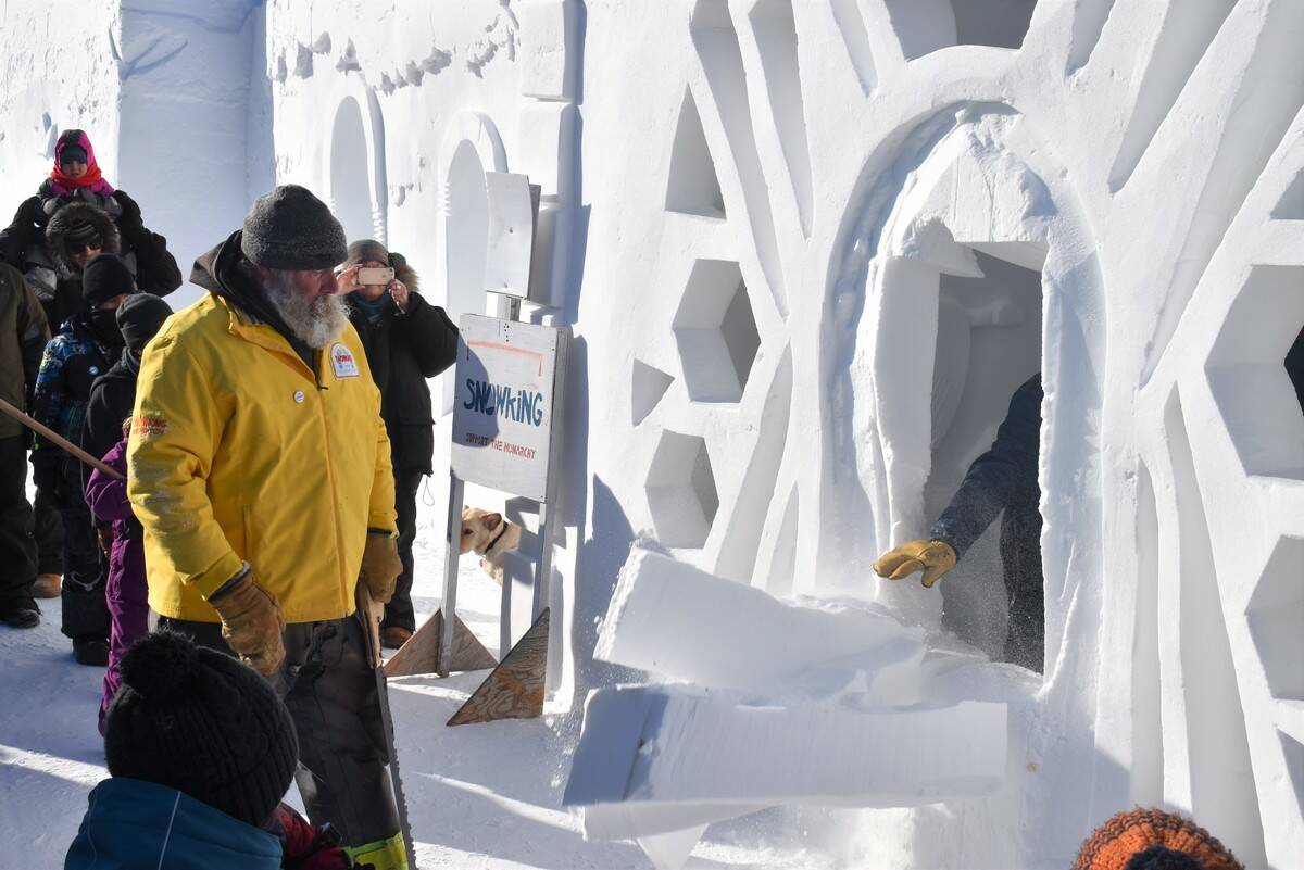 The Snowking, Anthony Foliot, getting some assistance as the door to the snow castle comes crashing down. Ethan Butterfield/NNSL photo