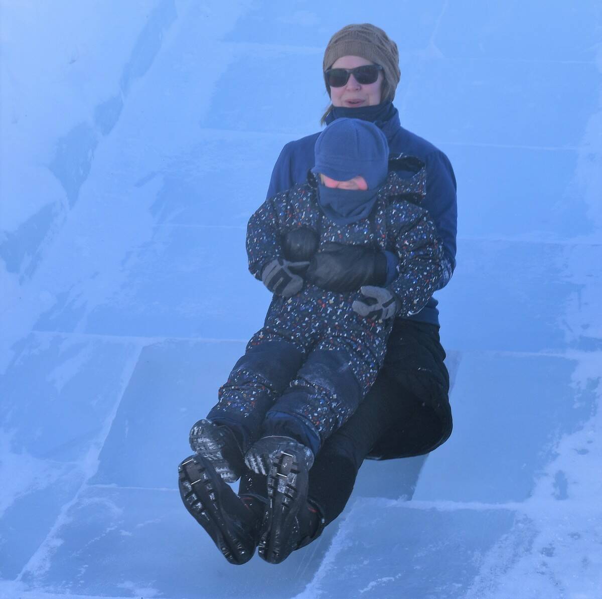 Kate Breen and her son, Peregrine, going down the ice slide. Ethan Butterfield/NNSL photo