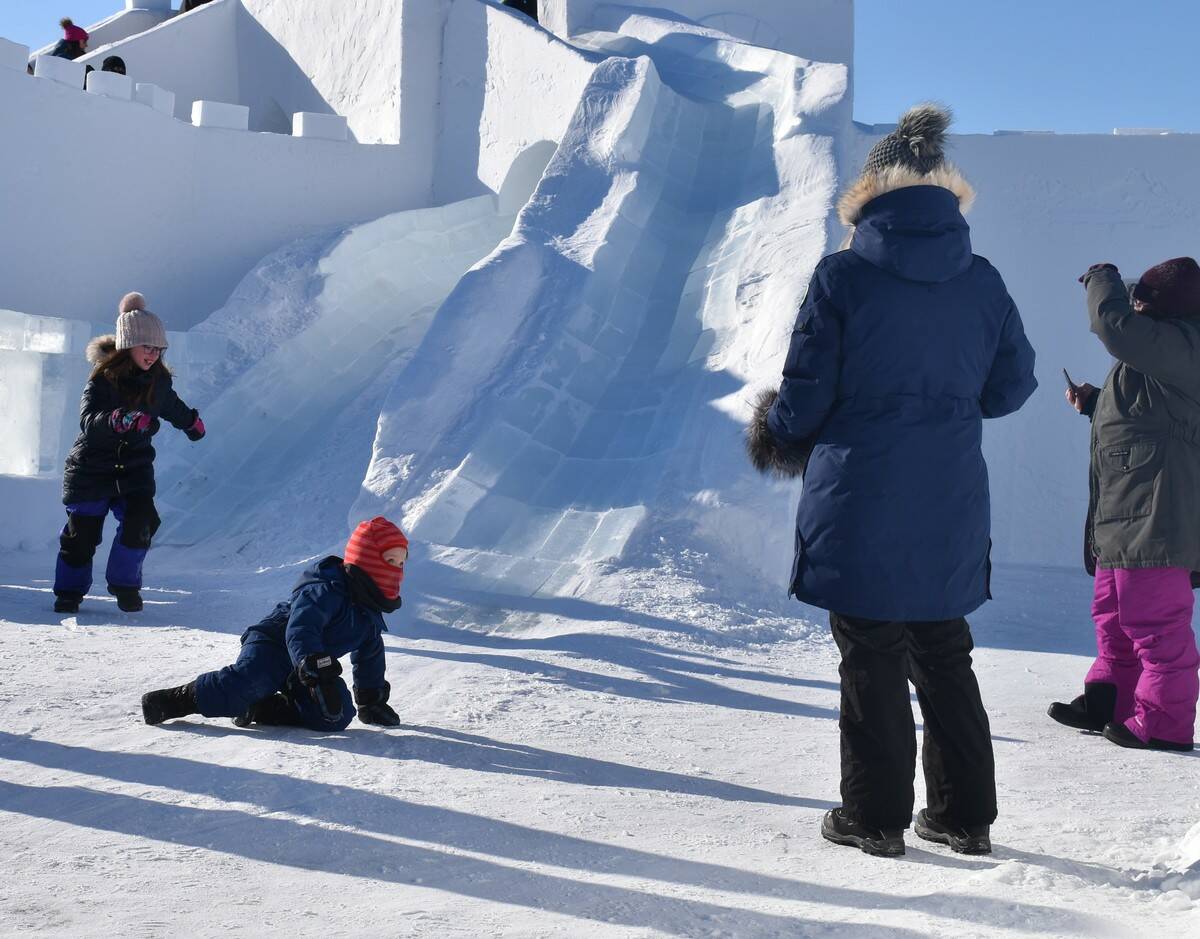 Families watch on as kids were sliding around on the ice slide inside the snow castle. Ethan Butterfield/NNSL photo
