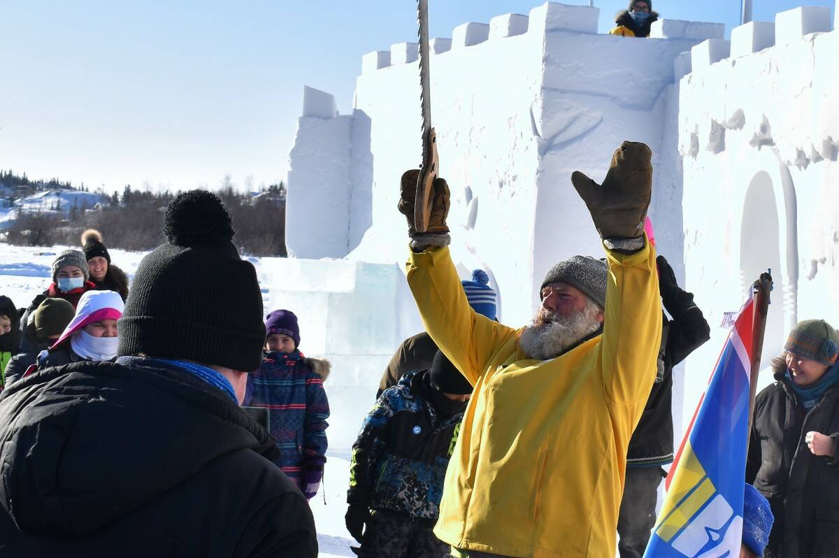 Snowking had his hands, and saw, up in the air like he just didnt care as the crowd cheered for the snow castles opening. Ethan Butterfield/NNSL photo