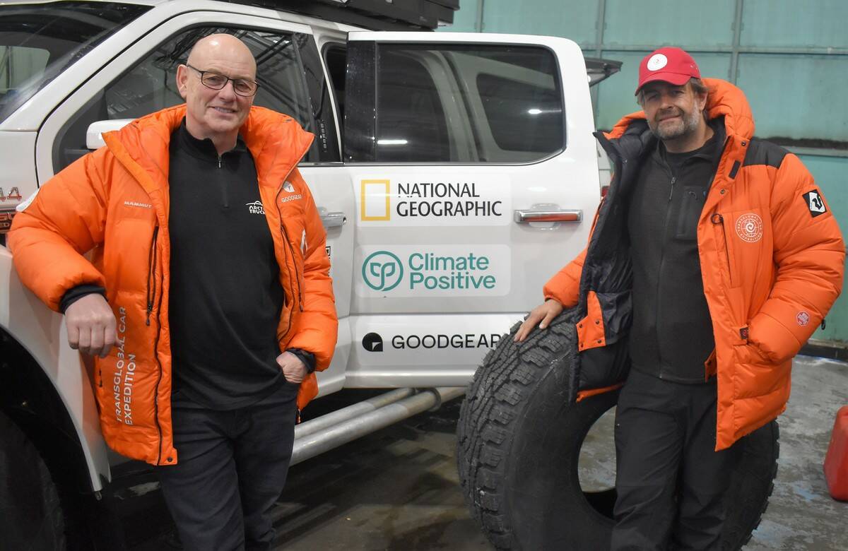 Emil Grimsson, left, and Andrew Comrie-Picard pose with a customized, electric Ford F-150 and one of the 44-inch tires it will be fitted with at Buffalo Airways, March 7. Ethan Butterfield/NNSL photo