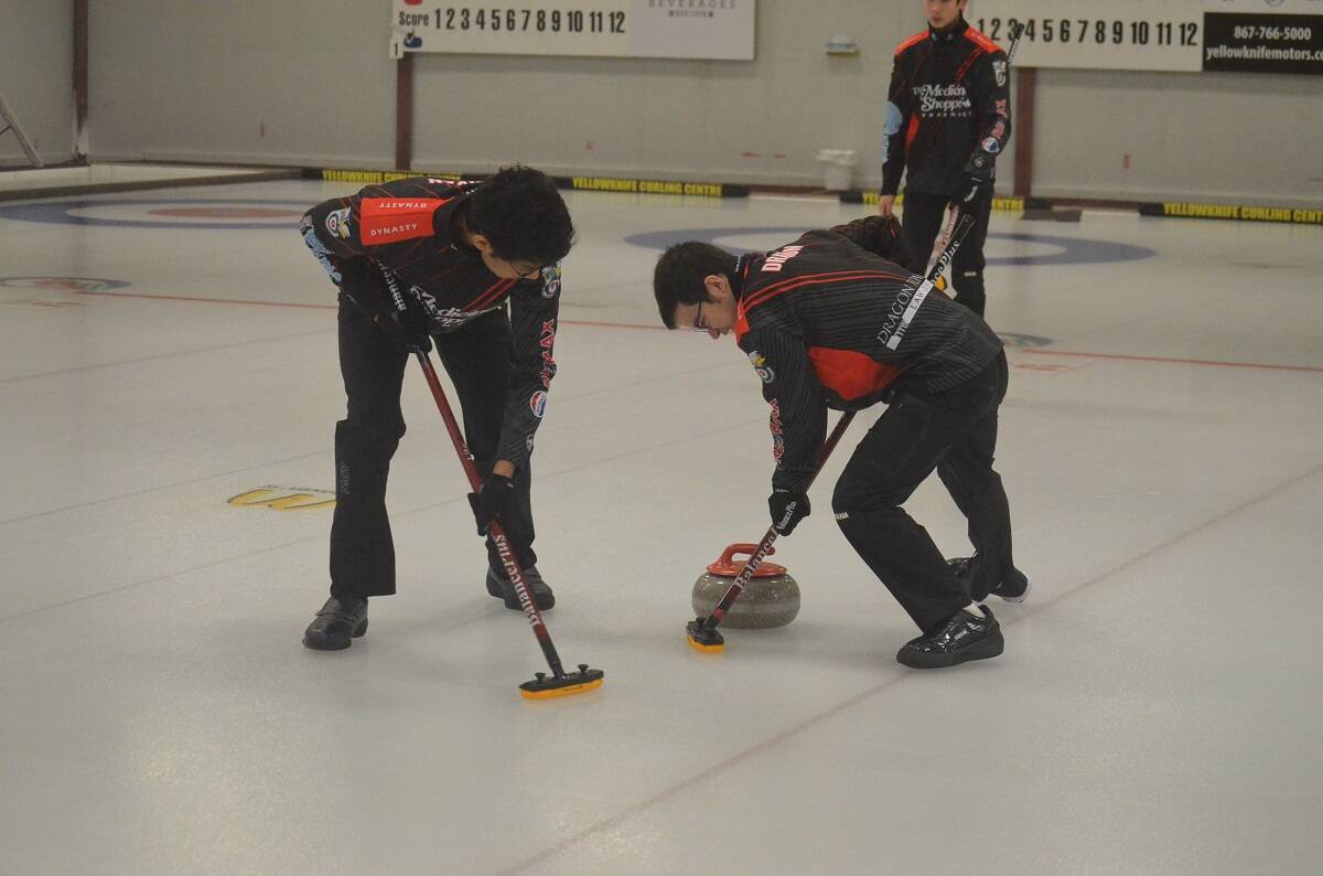 Tasir Bhuiyan, left, and Shawn Dragon lay down the brooms. James McCarthy/ºÚÁϳԹÏÍø photo