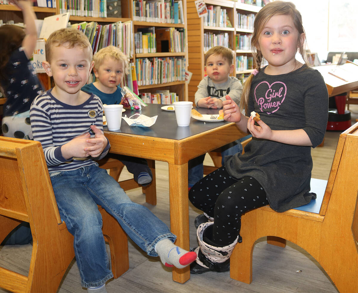 Slade Williams, four, Theo Williams, two, Gordon McMeekin, two, and Mackenzie McMeekin, six enjoy a moment together following the Easter Egg Hunt at the Hay River Library, April 9. Simon Whitehouse/NNSL photo