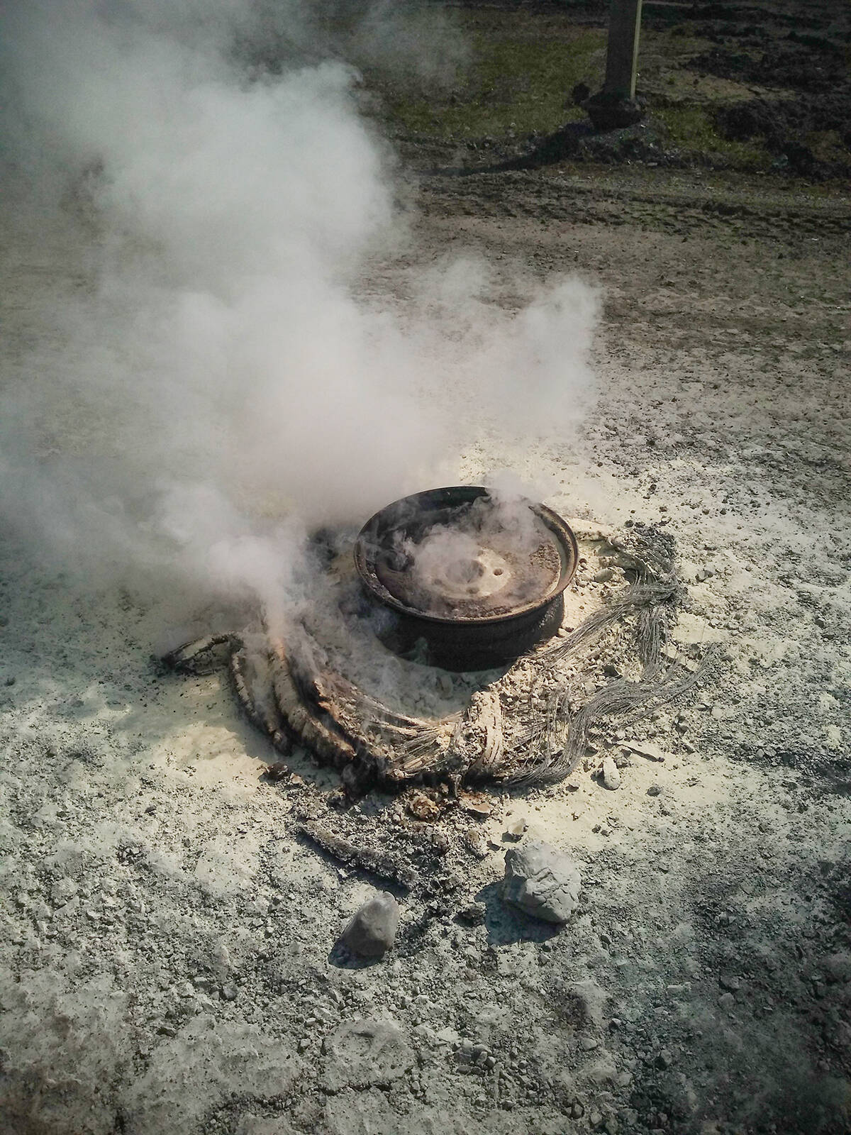 The smoldering remains of a tire fire at the Inuvik Cemetery June 16. Eric Bowling/NNSL photo