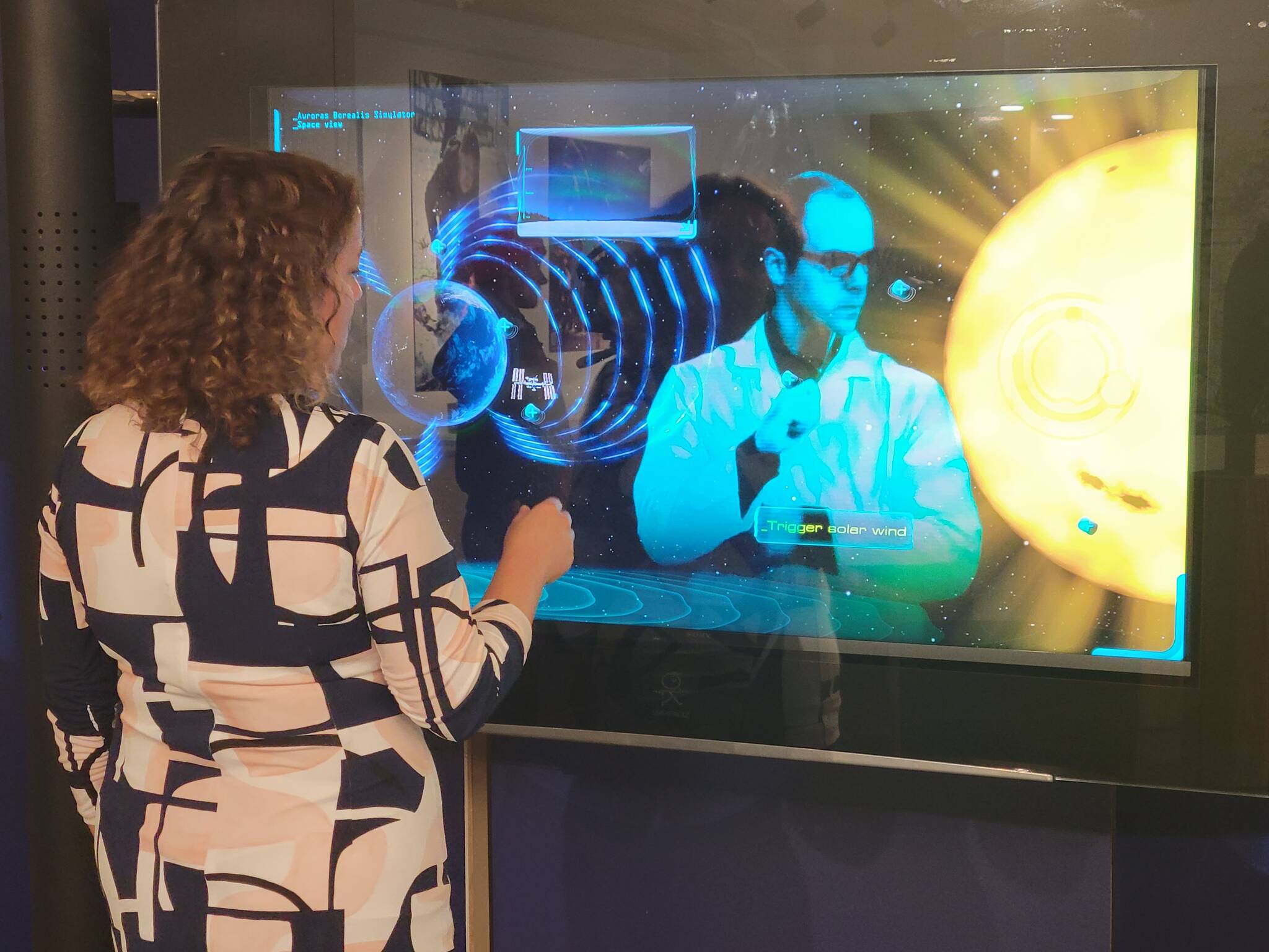 Yellowknife Mayor Rebecca Alty interacts with the touchscreen display at the visitor centre. The display teaches guests about the aurora. Ethan Butterfield/NNSL photo