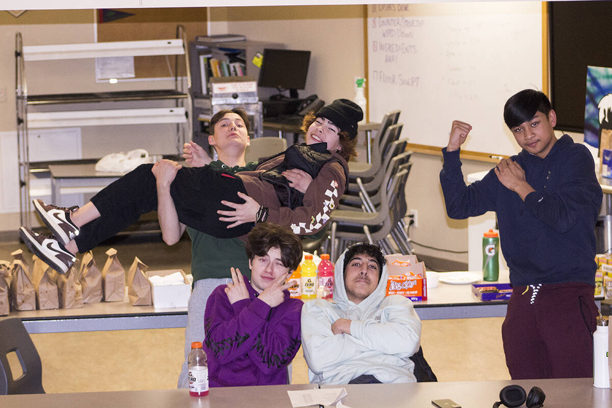 Jaxon Brodhagen Lennie, holding Orlando Blake, and Malakai Keegan-Drennan, Adam Mourtada and Descartes Dulay sell food and drinks to raise money for further basketball adventures. Eric Bowling/NNSL photo