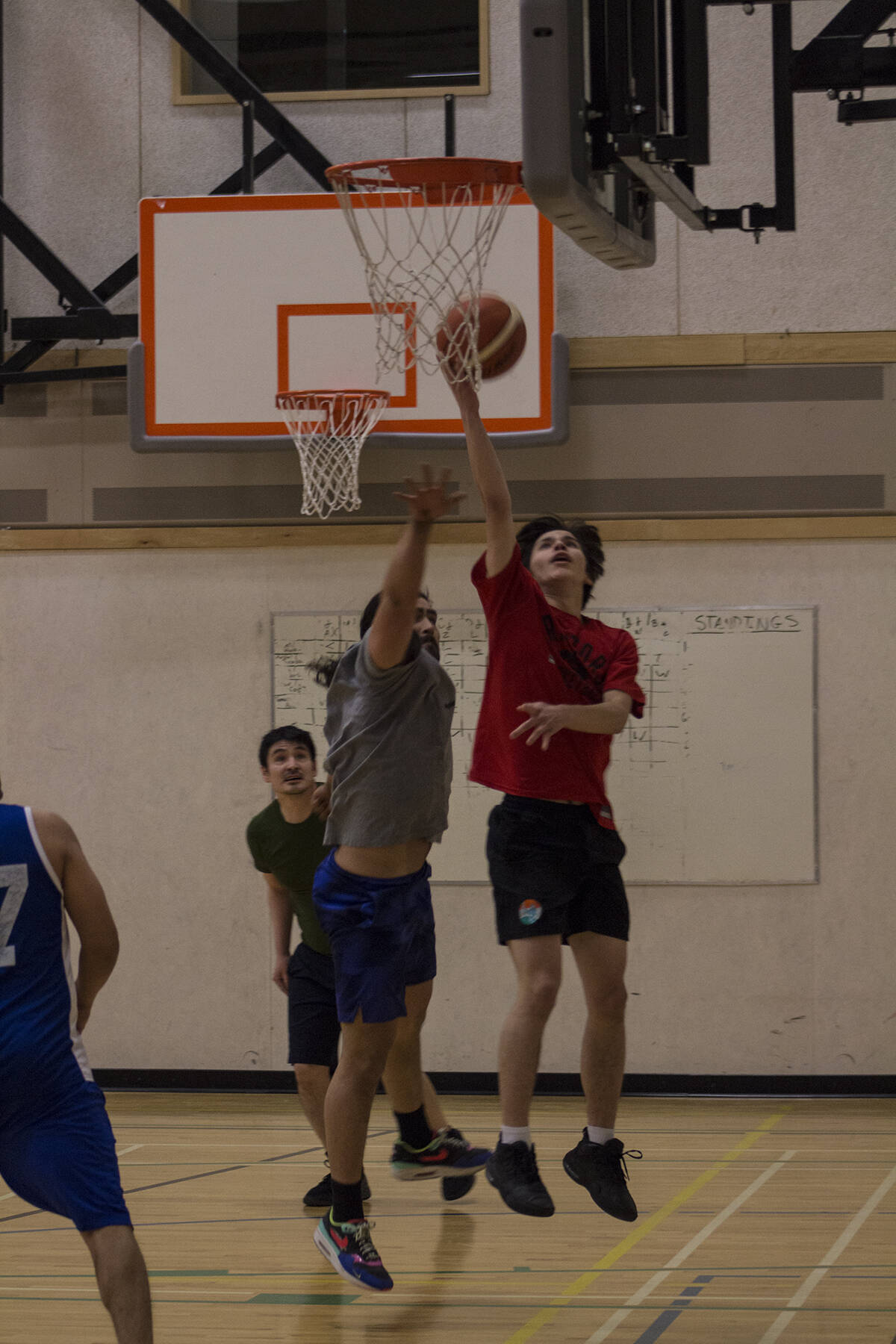 Kolsen Church performs a lay-up with Jackson Christi and Brent Wolki in pursuit. Eric Bowling/NNSL photo