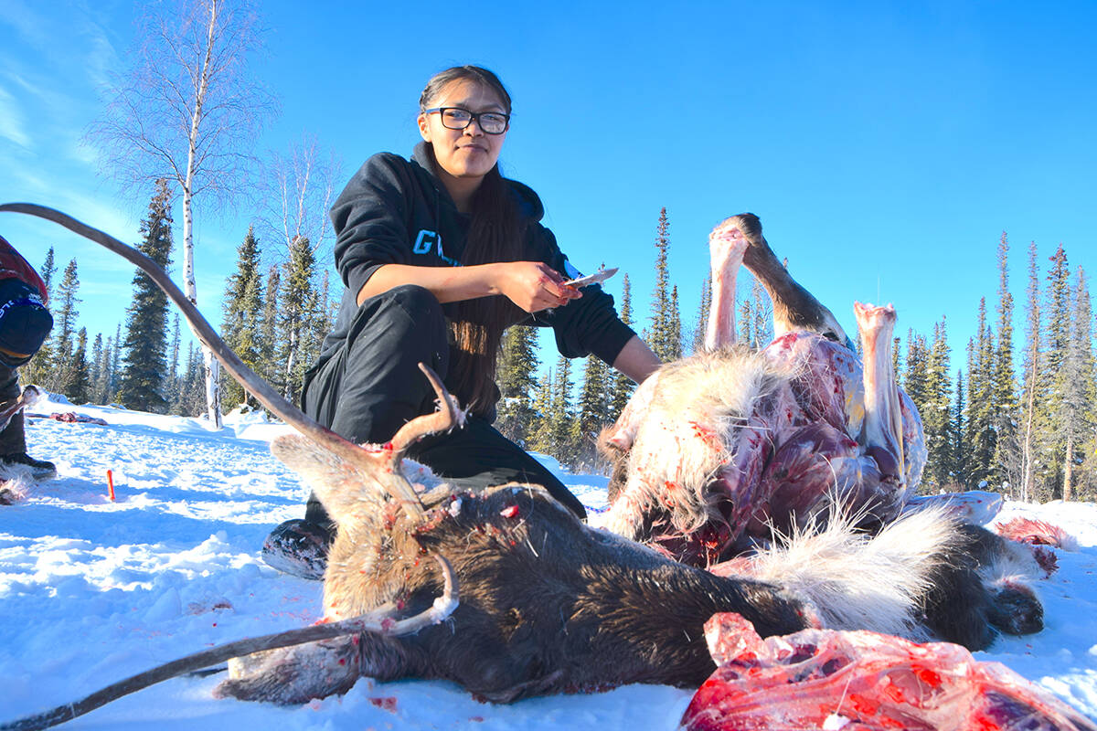 Malaenah Alexie cuts up a caribou caught near Curtain Mountain Camp. Photo courtesy Leah Vittrekwa