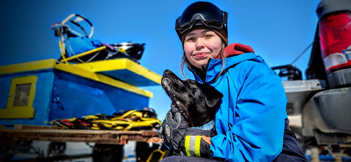 DeeDee Nasogaluak with one of her dogs in the lead up to the annual dog race at the 2023 Beluga Jamboree in Tuktoyaktuk April 29. Photo courtesy Karli Zschögner