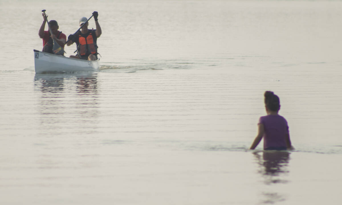 A child wades in the water as the first team makes their way to the Inuvik boat launch. Eric Bowling/NNSL photo