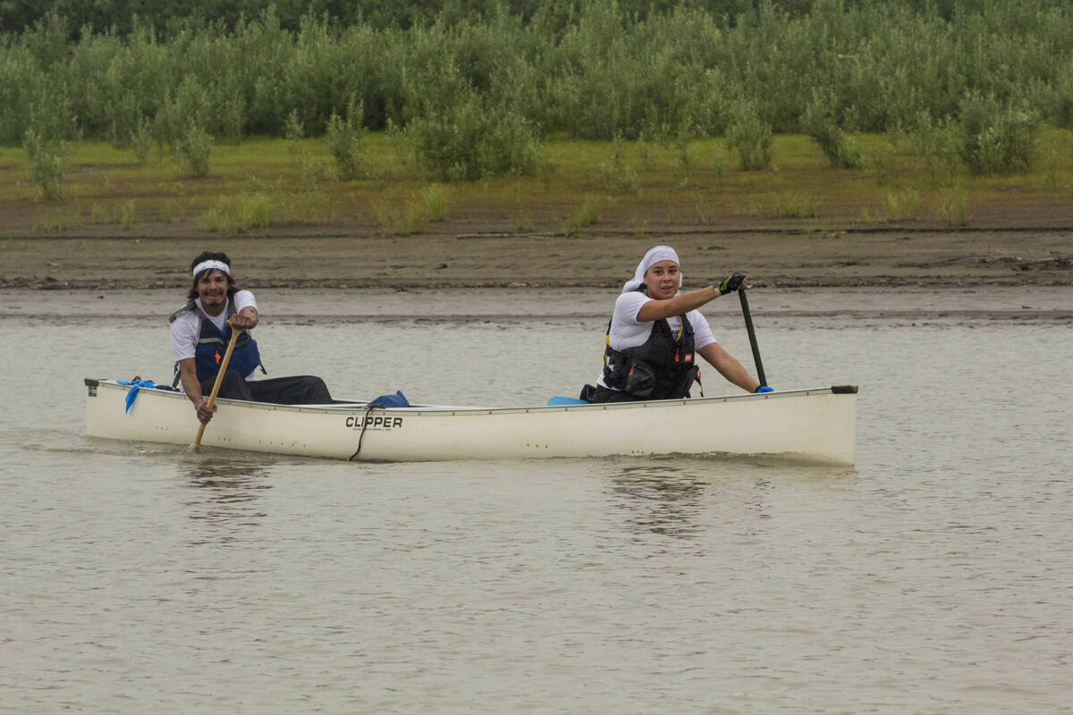 Joseph and Jeanette Tobac smile to the support boats as they paddle along. Eric Bowling/NNSL photo
