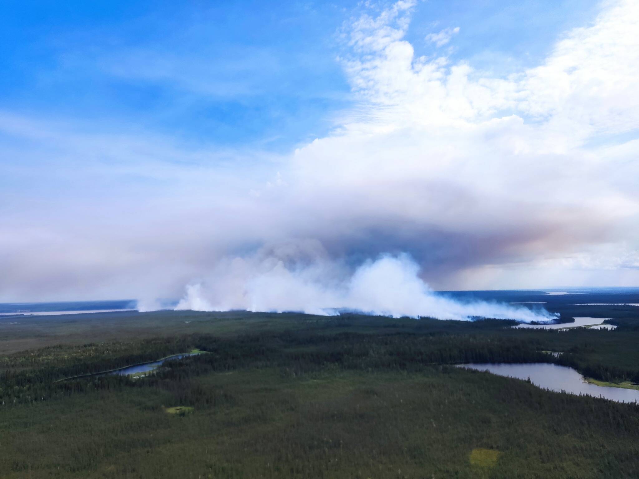 The wildfire near Tulita sends smoke billowing into the sky in July. Photo courtesy of GNWT