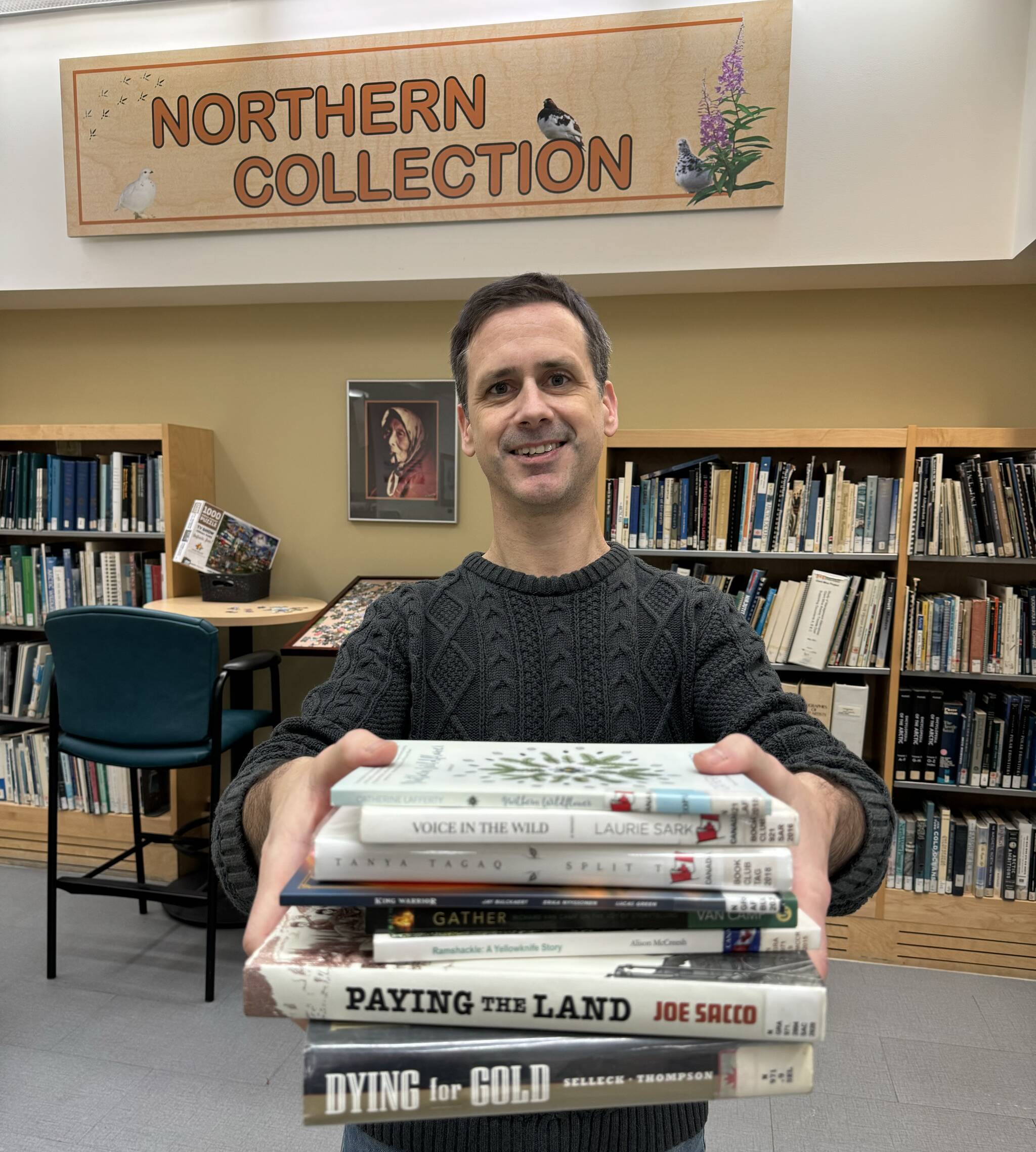 John Mutford, Yellowknife Public Library librarian, holds a stack of books written by Northern authors. Mutford said the Northern Collection section in the library continues to expand and now contains about 1,000 books, both fiction and non-fiction. Jill Westerman/NNSL photo