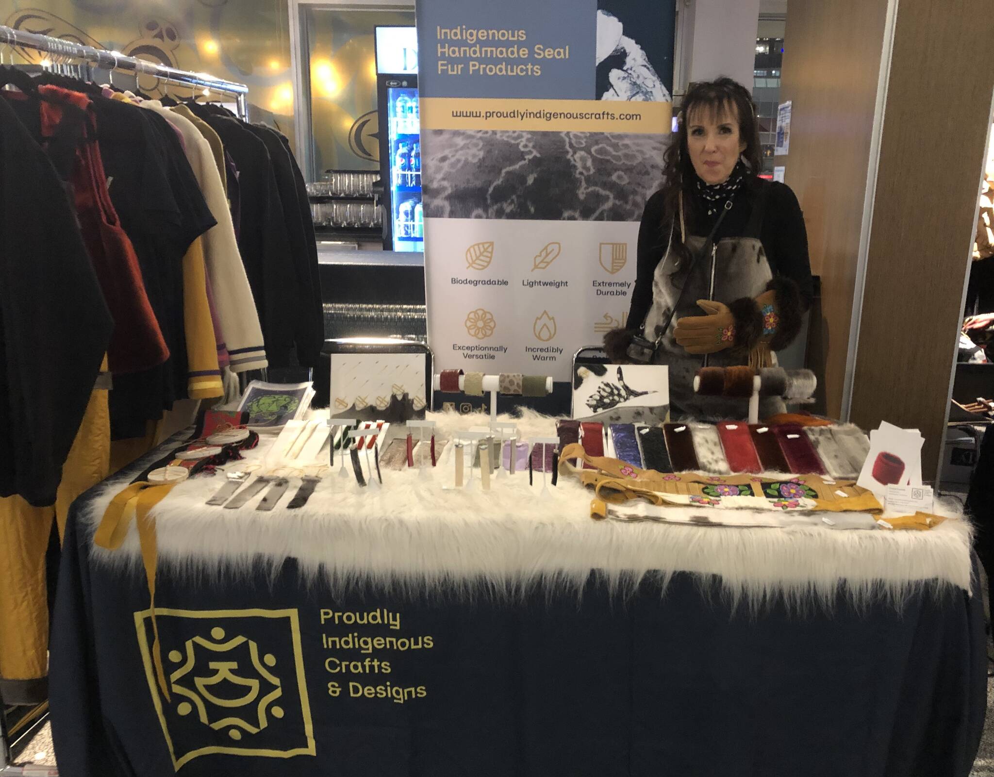 Yellowknife-based Métis designer Cheryl Fennell sits at her booth at the marketplace at Vancouver Indigenous Fashion Week. Fennell showed also showed 15 looks on the runway at the event, including a sealskin puffer jacket that everybody was going crazy for. Photo courtesy of NWT Arts