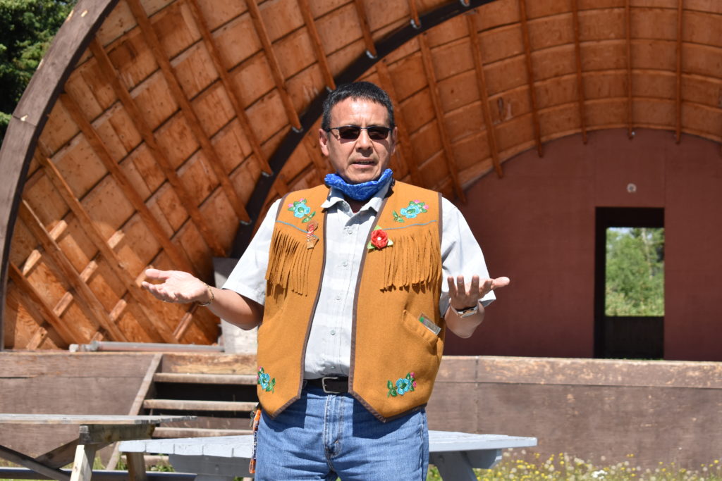 Ernest Betsina, N'Dilo chief of the Yellowknives Dene First Nation, stands with his hands open to the sky in front of an amphitheater near Yellowknife, NWT. It will be interesting to see what the process reveals about who has built cabins on our traditional territory, said Ernest Betsina, N'Dilo chief of the Yellowknives Dene First Nation. NNSL photo