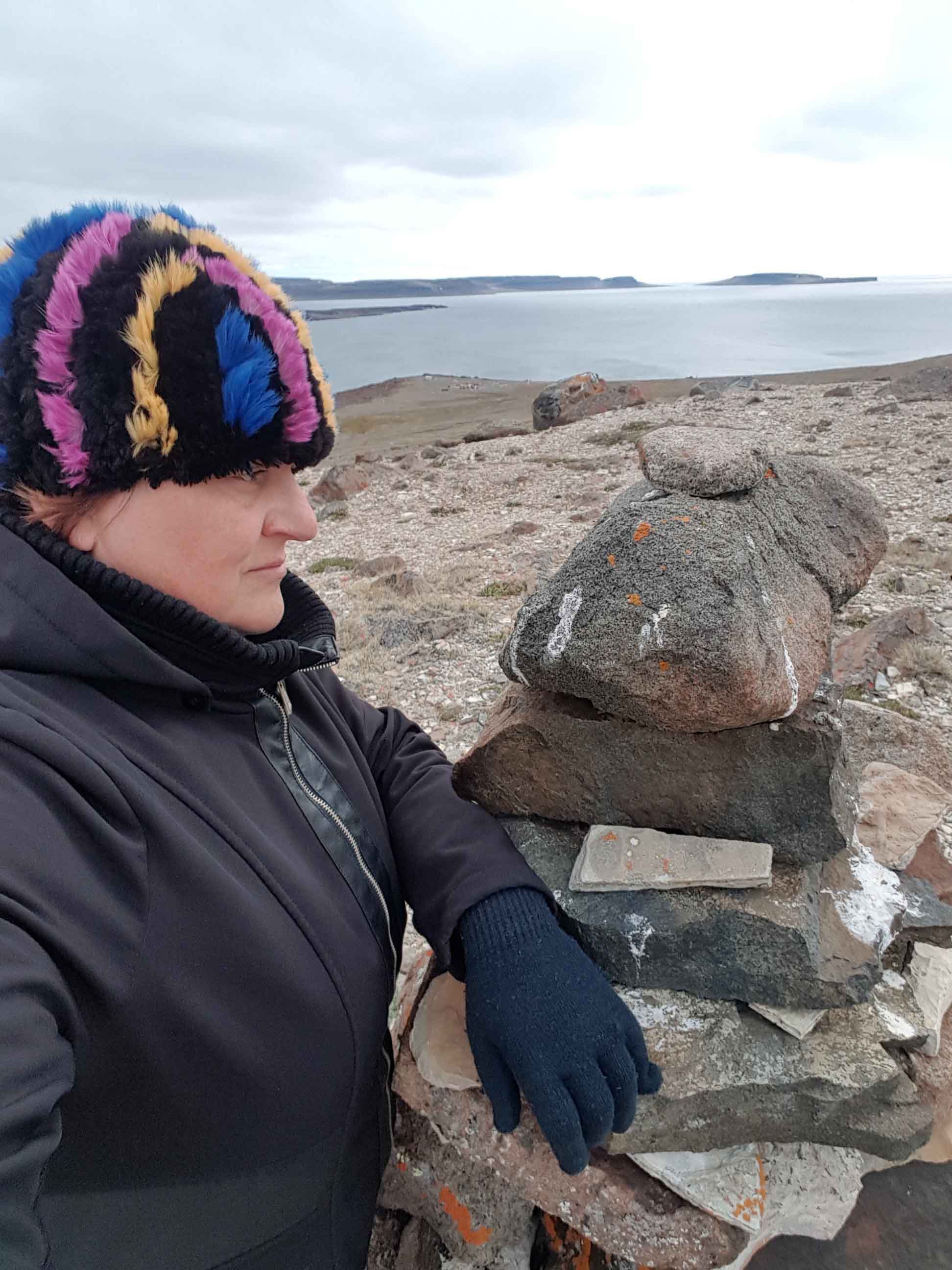 Hay River's April Glaicar explores the hills above Ulukhaktok on Victoria Island in July 2017 during phase one of her art project called 'Our True North', which features Ulukhaktok and Sachs Harbour. The results of that project - photos and glass art - will be presented to residents of Hay River on May 6. Photo courtesy of April Glaicar