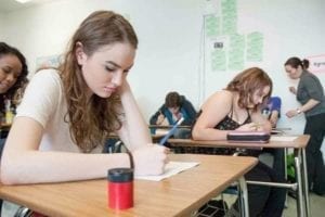 Melissa MacLellan, 15, left, and Erika Callahan, 16, prepare to take a test in Tomiko Robson's (far right) Grade 10 social studies class at Sir John Franklin High School on March 11, 2015. Department of Education, Culture and Employment officials say they plan to update the territorySA国际影视传媒檚 health curriculum along with the legalization of marijuana next July. - NNSL file photo
