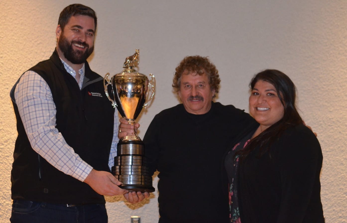 Richard Beck, centre, accepts the Canadian Championship Dog Derby winner's trophy from Nick Ballantyne, left, and Rebecca Plotner of Dominion Diamond Corporation during the awards dinner at the Explorer Hotel on Sunday. James McCarthy/NNSL photo
