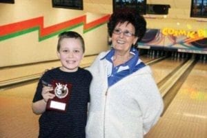 Ten-year-old Jacob Aylward receives the award as YBC Bowler of the Year in Hay River from coach Lillian Crook during a year-end event at Lizard's Lounge & Lanes on April 29. - Paul Bickford/NNSL photo