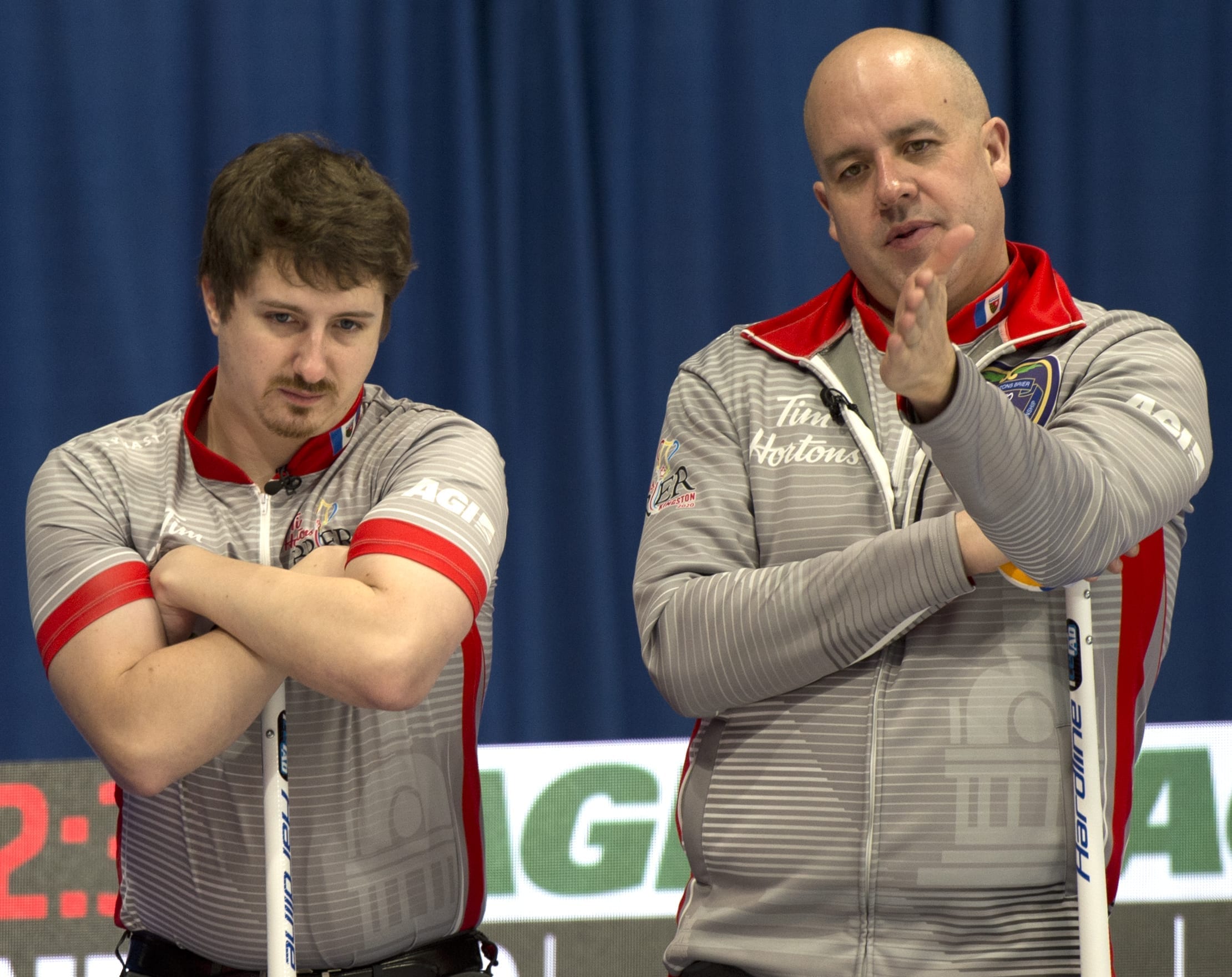 Jamie Koe, right, discusses the line with his third, David Aho, in between shots at the Tim Hortons Brier in Kingston, Ont., on Monday. Michael Burns/Curling Canada photo