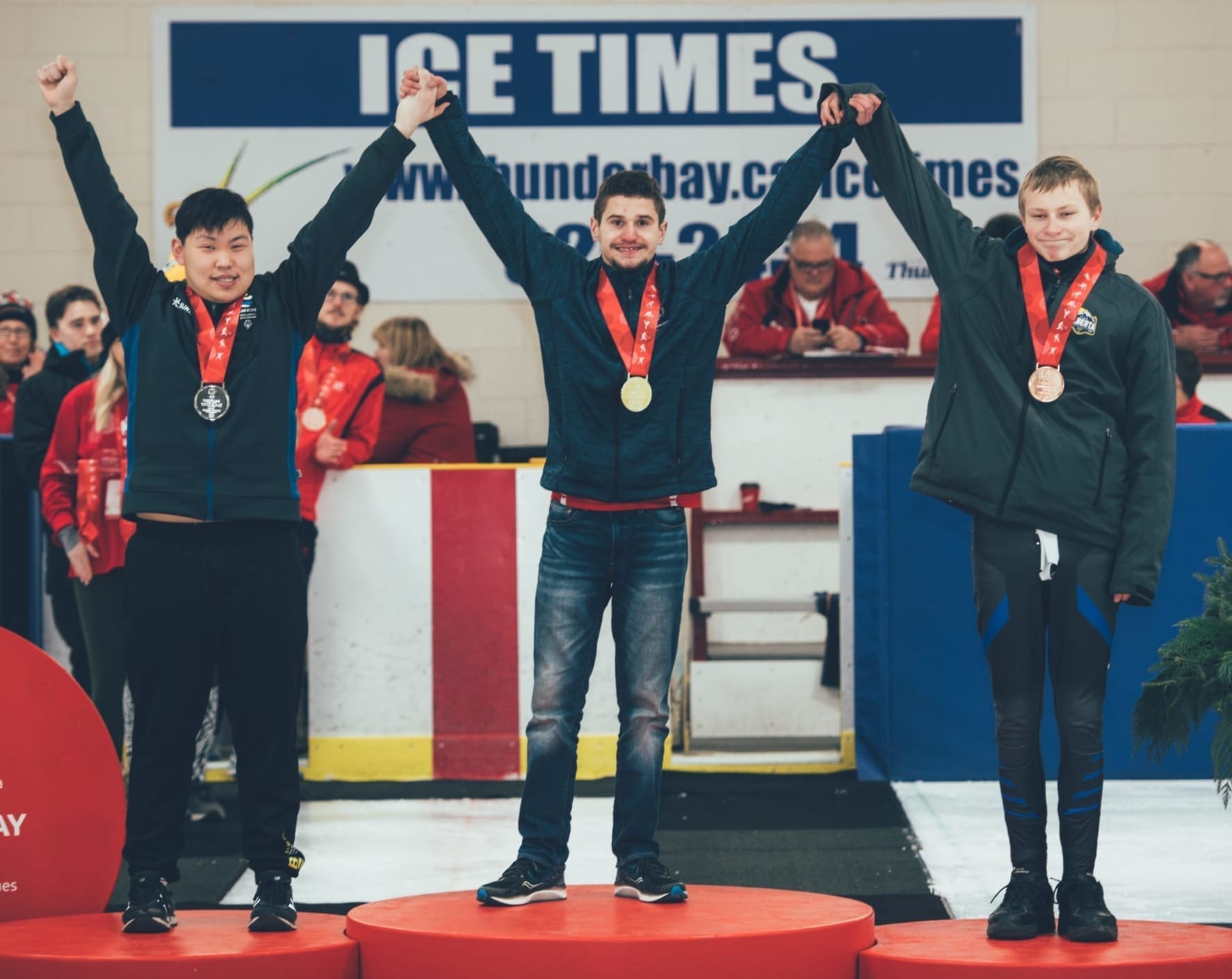 Josh Boudreau, centre, raises his arms in victory after winning gold in the men's 16-21 division in speedskating at the Special Olympics Canada Winter Games in Thunder Bay, Ont., on Feb. 28. With him are silver medallist Nicholas Chow of B.C., left, and bronze medallist Tyler Larson of Alberta. photo courtesy of Special Olympics Canada