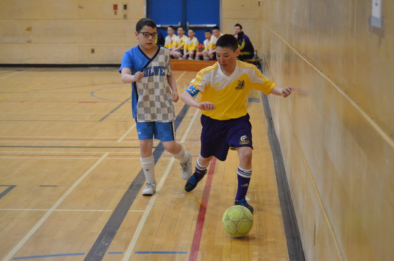 Kugluktuk's Jonathon Ihumatak tries to shield the ball from an Inuvik Wolves player during Grade 6 boys division playoff action at Junior Super Soccer in Yellowknife on April 28. James McCarthy/NNSL photo