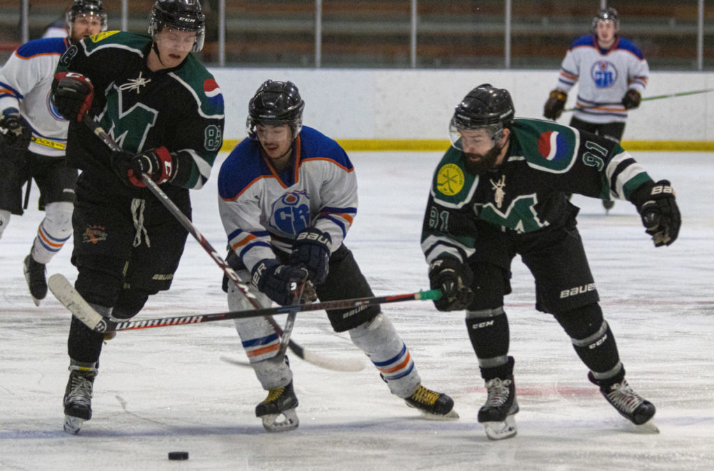 The Weaver and Devore Marauders' duo of Brady Daniels, left, and Kyle Kugler, right, try to squeeze out Ace's Curtis German on a rush during the Yk Rec Hockey League's championship game at the Multiplex on March 31. photo courtesy of Rob Hart 