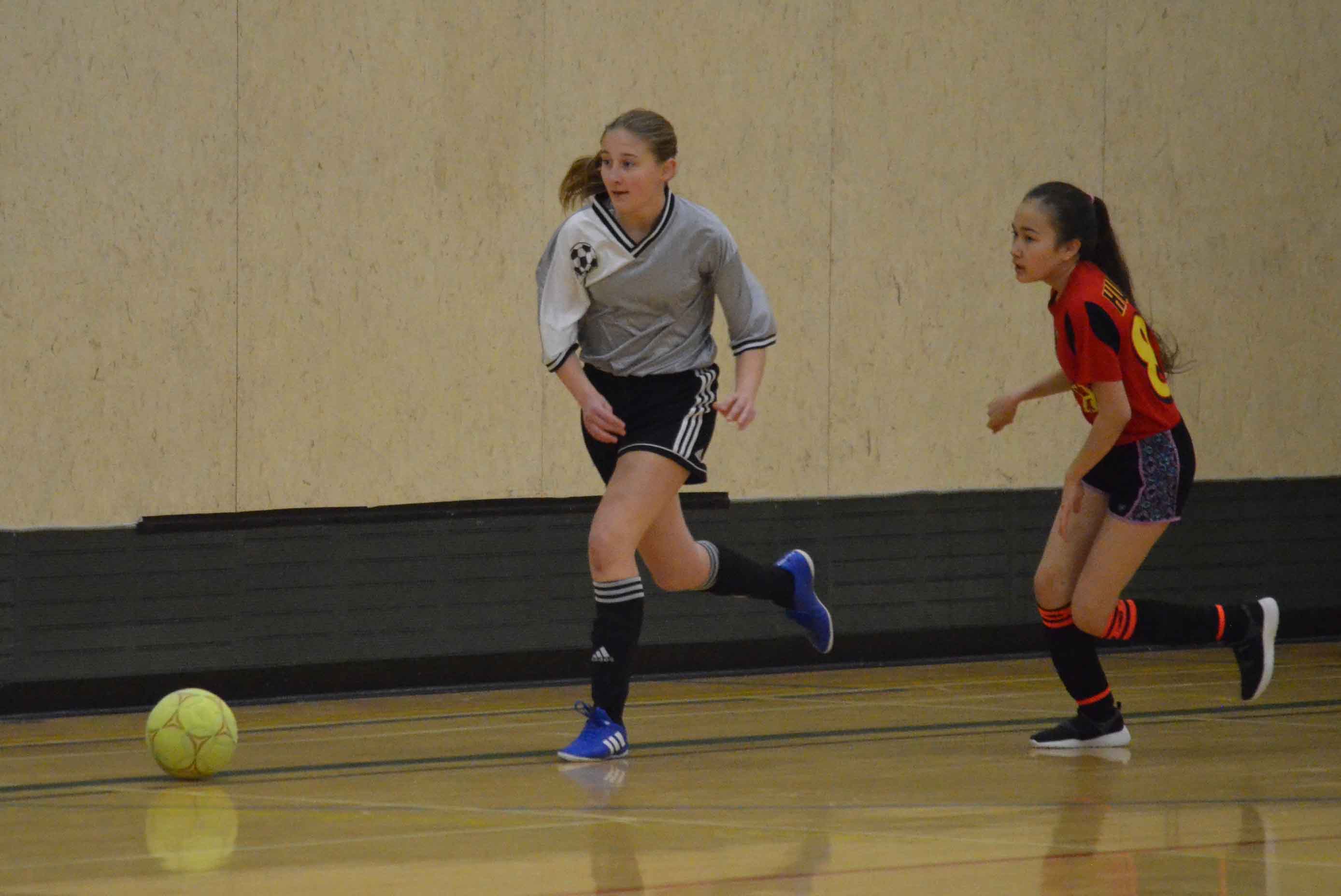 Keira Coakwell, left, of the Stittsville Hay River girls' team chases the ball during the Junior Super Soccer tournament in Yellowknife. The team finished second in its division. James McCarthy/NNSL photo