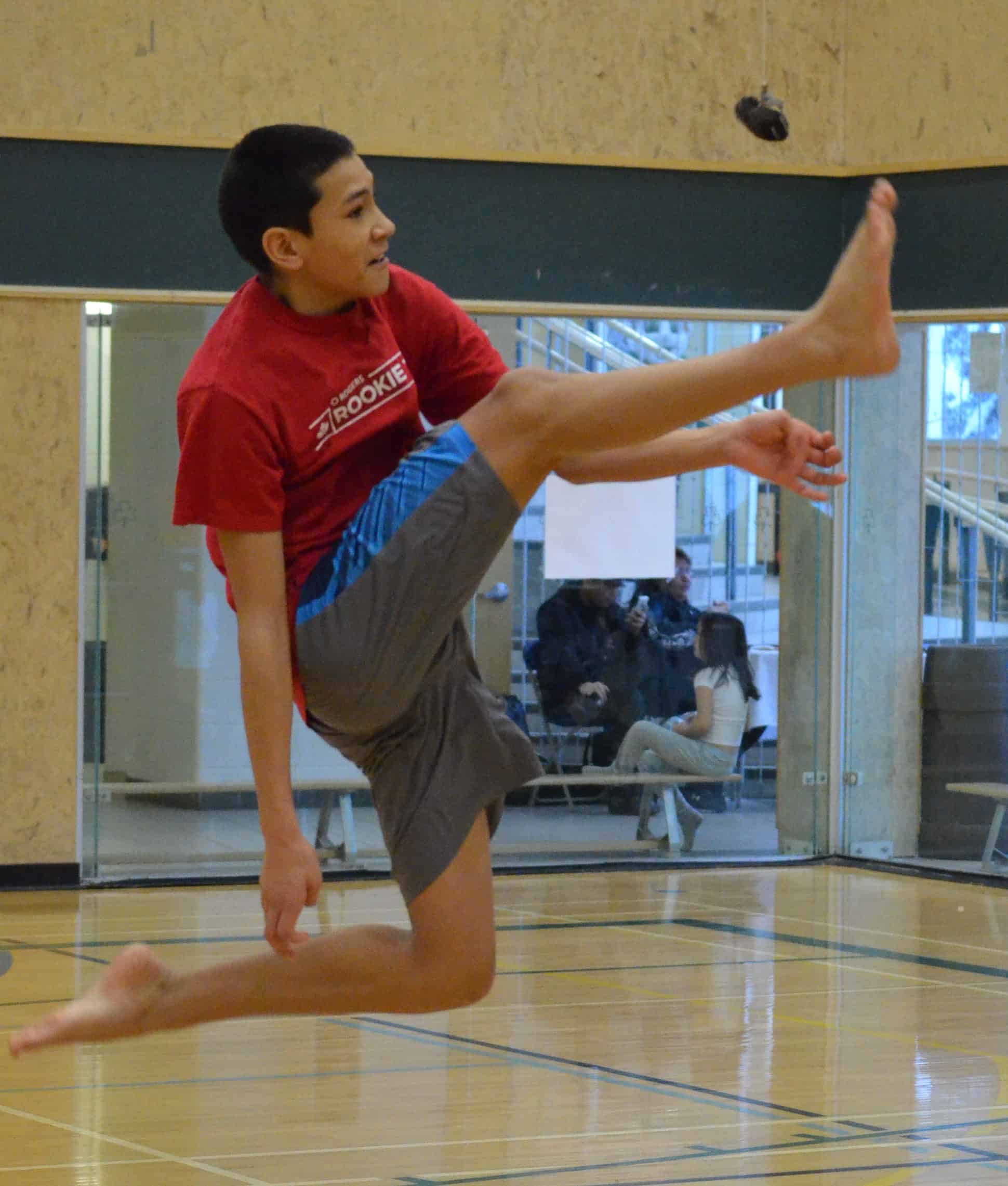 Titan Klengenberg of Mildred Hall School takes flight on his way to winning the senior one-foot high kick during Yellowknife Catholic Schools' Regional Youth Traditional Games Tournament at St. Pat's Gymnasium on Saturday. James McCarthy/NNSL photo