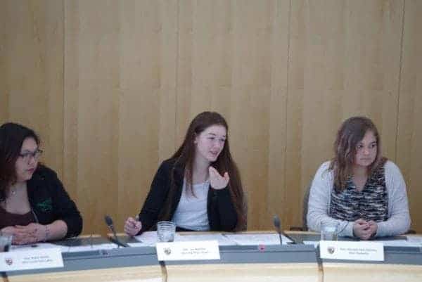 Myha Martin, right, representing Inuvik Twin Lakes, Lisa Boutilier, representing Hay River South, and Macayla Flett-DaCorte, representing Thebacha, during a sitting in the Youth Parliament at the Government of the Northwest Territories legislative assembly on May 11. Boutilier responded to a motion to regulate marijuana across the territory, which passed with 14 votes for, three against and one abstention. Emelie Peacock/NNSL Photo