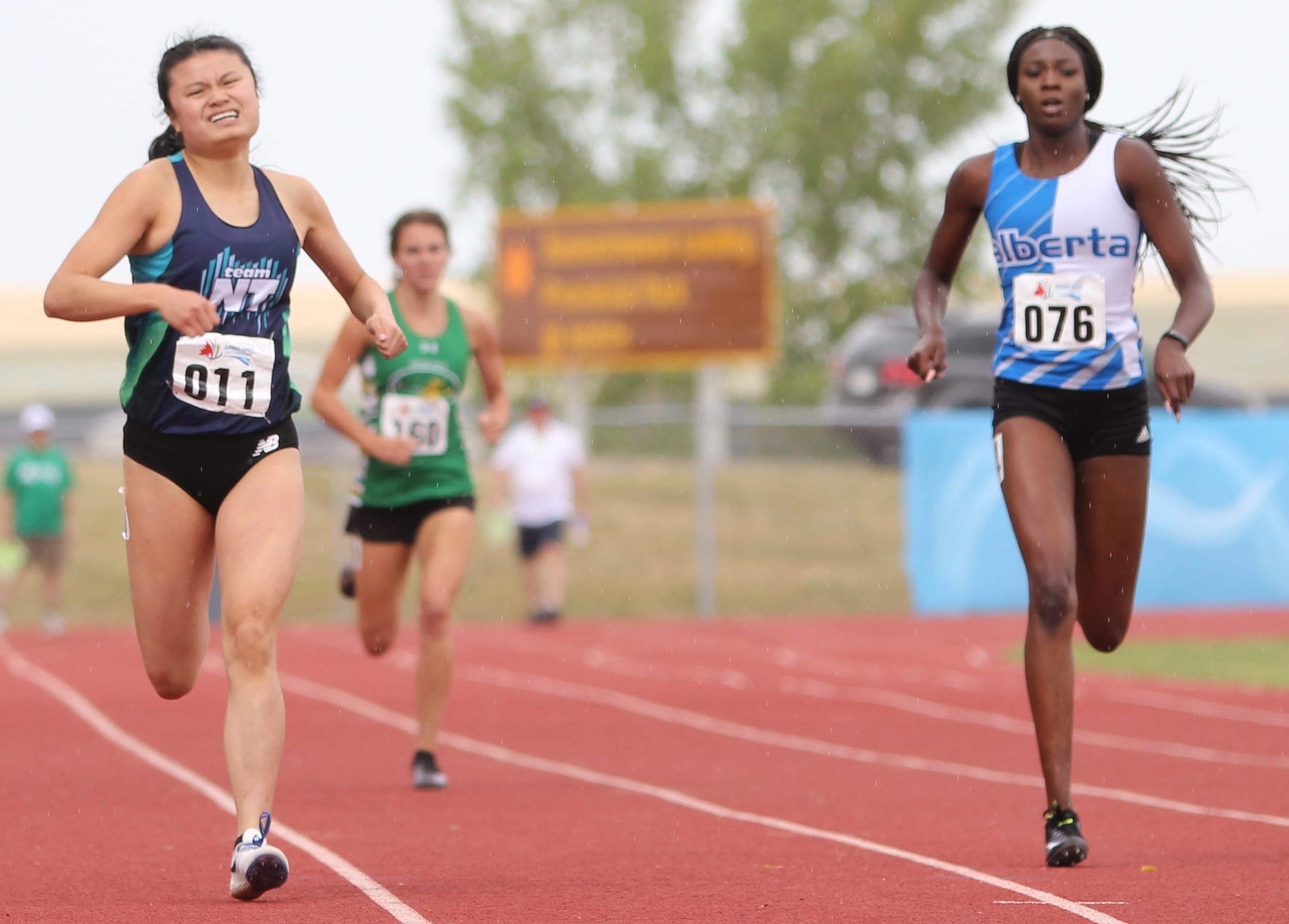 Fiona Huang of Hay River, left, is neck-and-neck with Anok Tiordit of Alberta down the stretch in the heats of the girls 400-metre dash at the Western Canada Summer Games in Swift Current, Sask., on Thursday. photo courtesy of Rob Hart