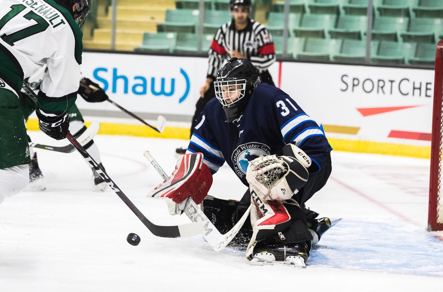 Liam Tereposky gets set to make a stop on a Prince Edward Island player during boys hockey action at the Canada Winter Games in Red Deer, Alta., on Feb. 17. Brandon White/Canada Winter Games photo