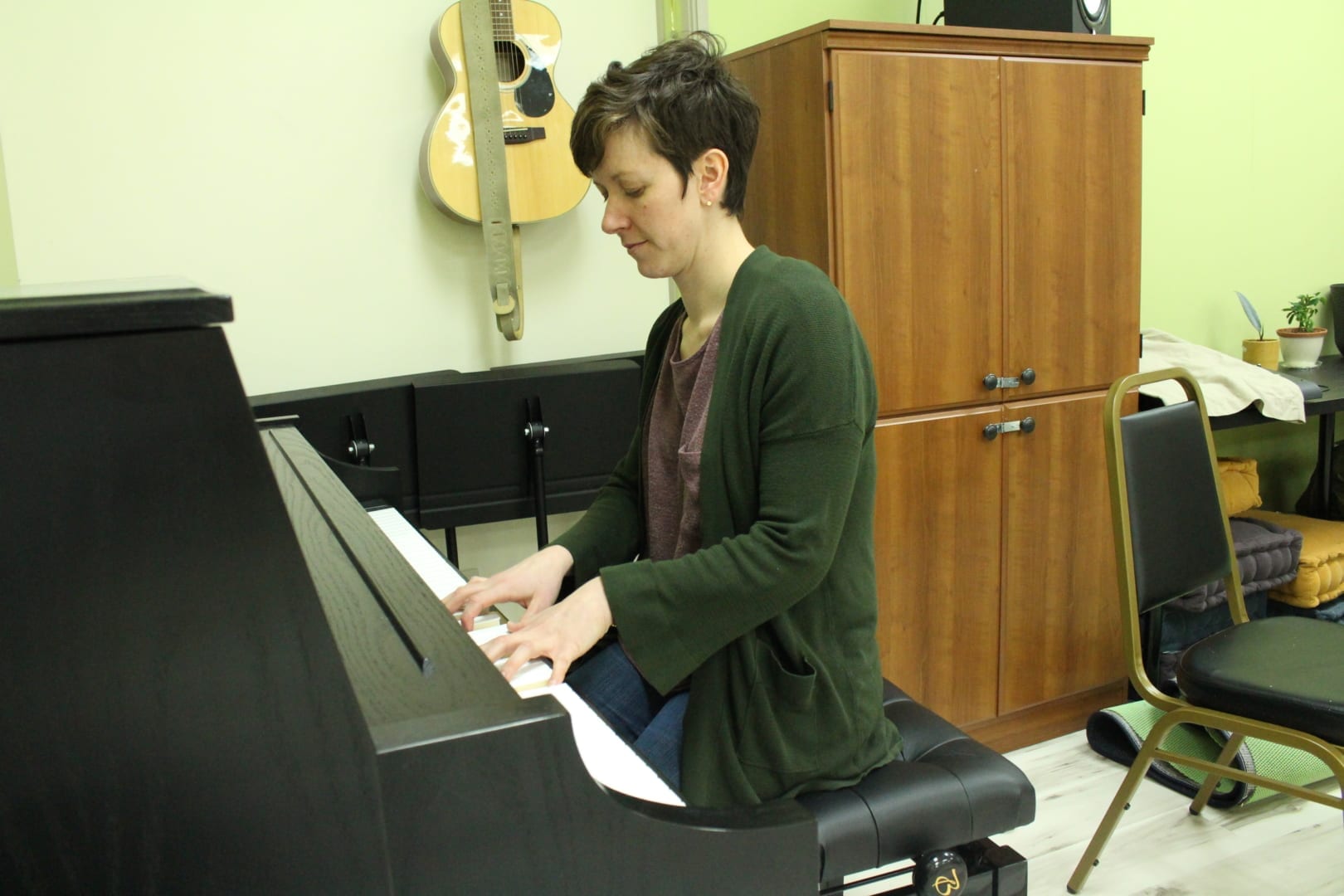 Mary Kelly plays a new piano she able to buy to help outfit her new business. It is one of several instruments she has available at Music Space. Brett McGarry/NNSL Photo