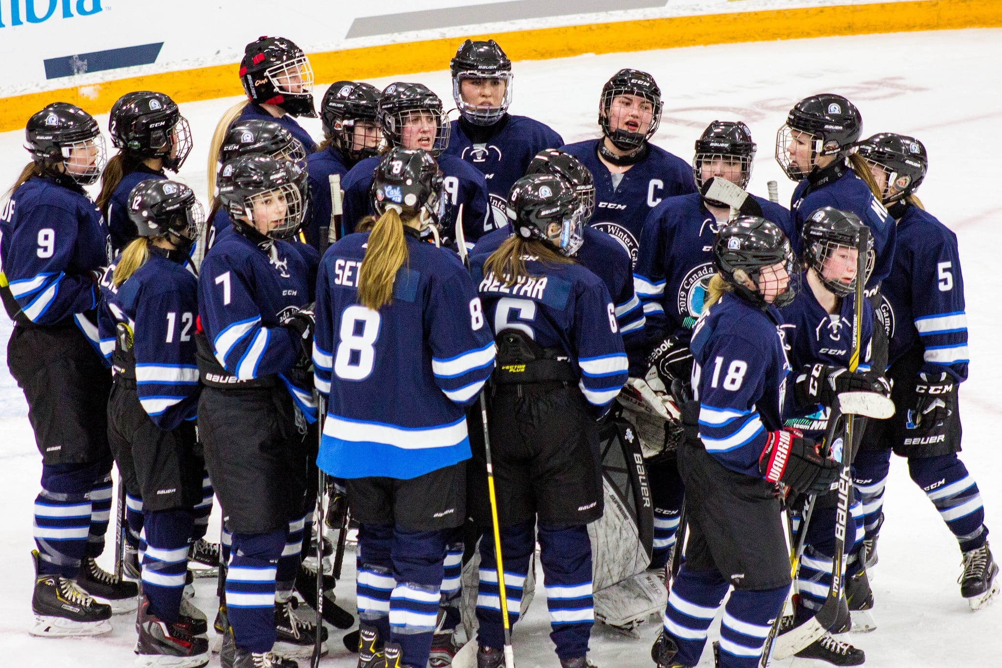 Team NT's girls hockey team gathers around following their game against Prince Edward Island at the Canada Winter Games in Red Deer, Alta., on Feb. 24. Mel Bolin/Canada Winter Games photo