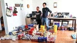 Abluqta Society president Joseph Arnasungaaq and former Thrift Store manager Sharon Alerk display the original food bank donations the society received in May of 2018. Photo courtesy Erin Strachan