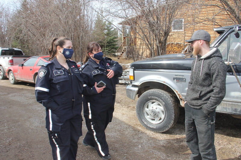                                             On May 7, Firefighters Crystal Potter, left, and Korin Carter advise Old Town resident Bryan Seaton that an evacuation order had been issued by the Town of Hay River because of the threat of potential flooding. Like some other residents of Vale Island, Seaton decided to stay on the island. Paul Bickford/NNSL photo                            