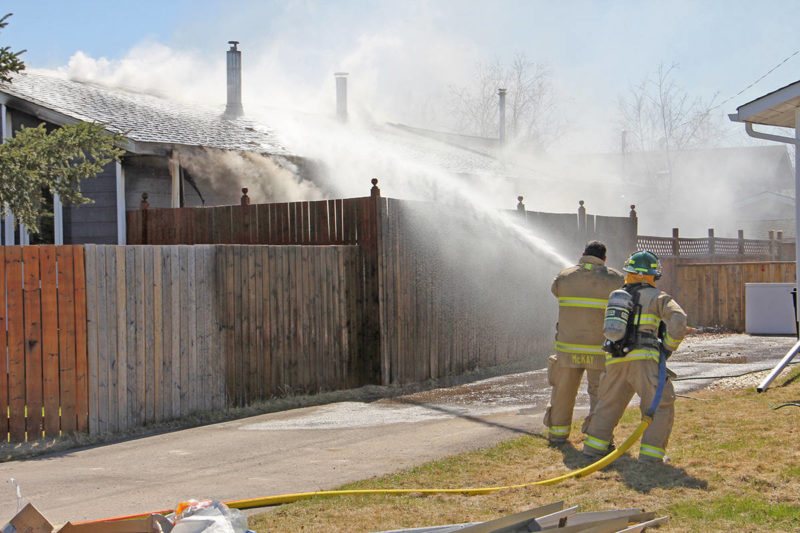                           Members of the Hay River Fire Department battle a May 25 house fire on McBryan Drive. Paul Bickford/ϳԹ photo          